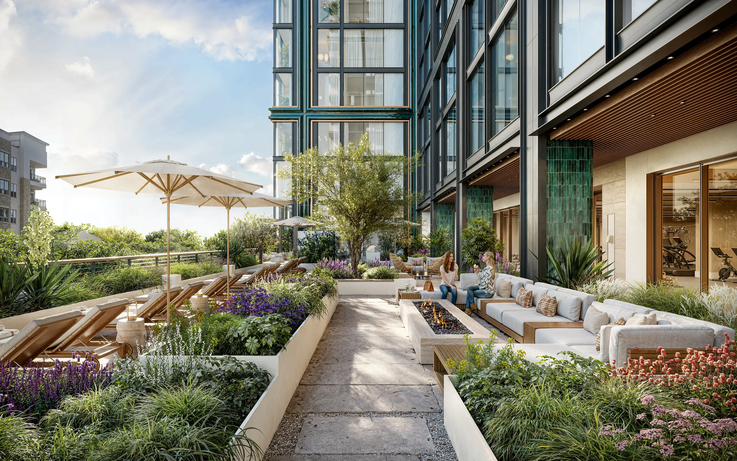 Rendering of the landscaped sun terrace, with sun loungers under umbrellas, a fire-pit seating area and residents in conversation, beside the tower's glass and green-tile facade