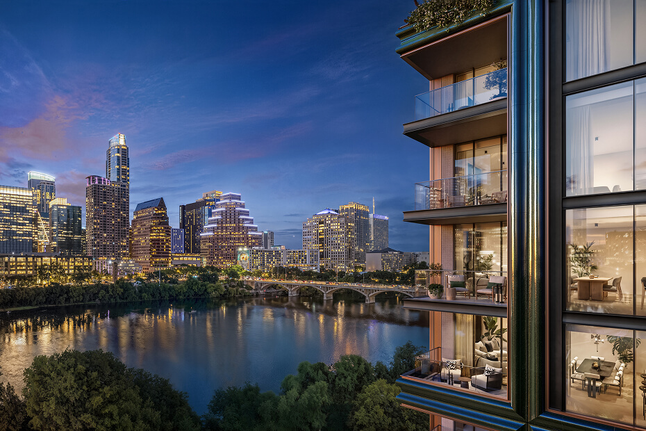 Dusk view of the downtown Austin skyline across Lady Bird Lake, seen past the lit balconies of a residential tower